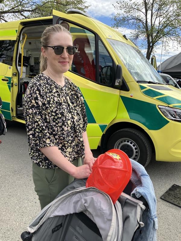 Nainen seisoo ambulanssin edessä. 